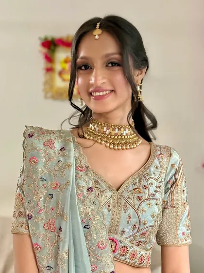 A smiling portrait of the bride. The makeup is minimal and fresh, focusing on enhancing her natural features.