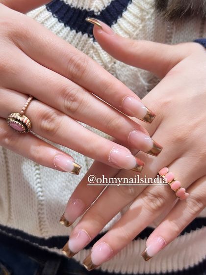 Chic and classy chrome tips. This design elevates the classic French manicure by using a reflective gold chrome polish for the tips on long, square-shaped nails.