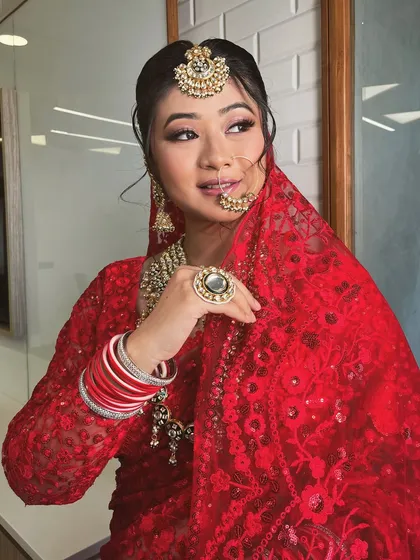 A series of a model in a beautiful red lace saree. This classic yet modern piece is versatile enough for a bridal trousseau shoot or a festive occasion.