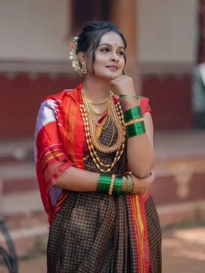 A student's work showcasing a different traditional look, with a focus on heavy gold jewellery and a classic saree drape.