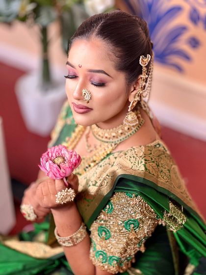 A close up of the model's soft, shimmery eye makeup and the delicate details of her nath.