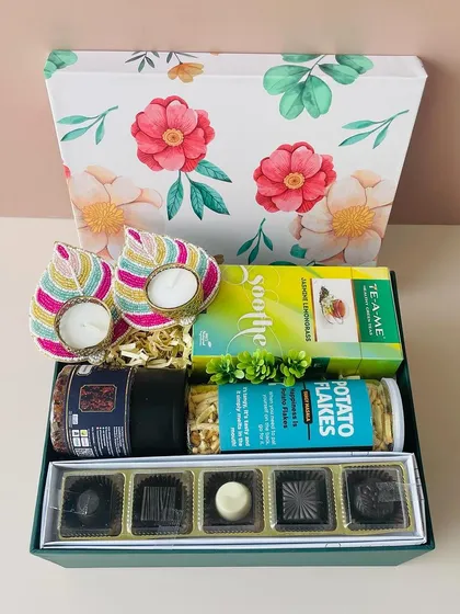 Here is the second option for the same floral box. This one is curated with premium chocolates, tea, snacks, and beaded leaf T-light holders.