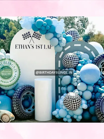 A close-up of the personalized "Ethan's 1st Lap" backdrop.