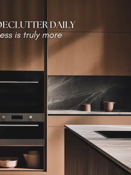 Declutter daily, because less is truly more. This kitchen design emphasizes this principle with its integrated ovens and minimalist wood-paneled cabinets, creating a clean and harmonious aesthetic.
