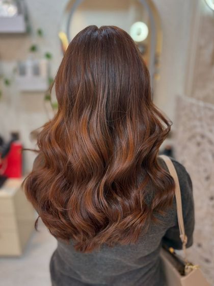 The back view of the copper mocha brown colour, styled in soft waves to showcase the rich tones and healthy shine.