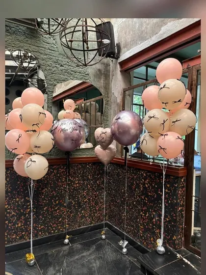 Custom balloon bunches for a stylish bridal shower. These arrangements feature a mix of pastel, metallic, and custom-printed balloons with eyelash details, adding a fun and fashionable touch to the party decor.