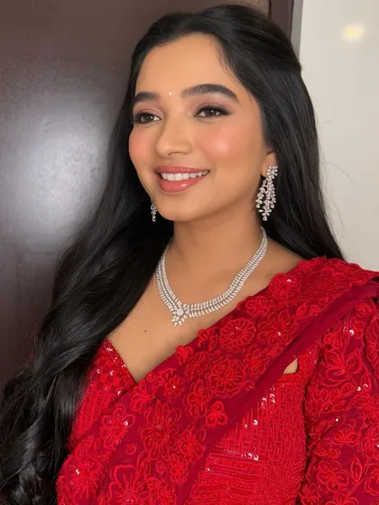 A close-up on her glowing smile. The soft, shimmery eye makeup and flawless skin create a look of pure radiance.