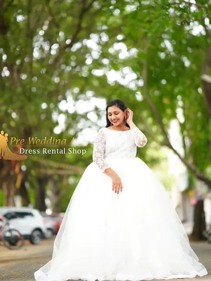 For that classic fairytale moment, I have a selection of white ball gowns. This one features a full tulle skirt and delicate lace sleeves, offering a timeless and romantic silhouette. It's perfect for creating soft, dreamy pre-wedding pictures.