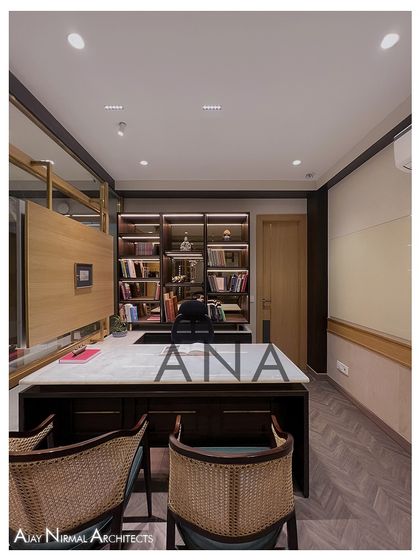 A straight-on view of the custom-designed MD table and rear book cabinet in the Jain Cosphere Office. The clean lines and rich materials project an image of professionalism and taste.