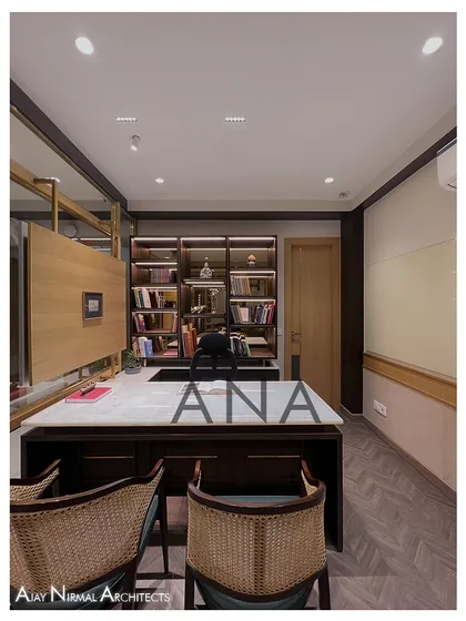 A straight-on view of the custom-designed MD table and rear book cabinet in the Jain Cosphere Office. The clean lines and rich materials project an image of professionalism and taste.