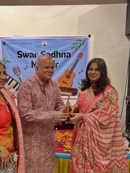 An adult student is awarded for her dedication and performance. Our classes are a welcoming space for learners of all ages to pursue their musical goals and be celebrated for their progress.