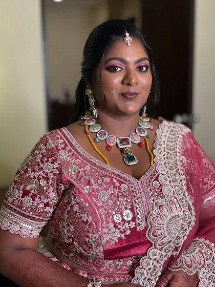 All eyes on her! This regal reception glam features bold pink shimmery eyes, a defined crease, and fluttery lashes for a truly show-stopping look.