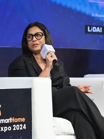 A seasoned professional contributes her valuable insights during a panel discussion on smart home technology.