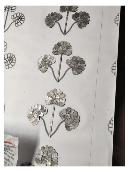 A close-up of the Thikri panel in progress, showing the texture and reflection of the individual glass fragments.