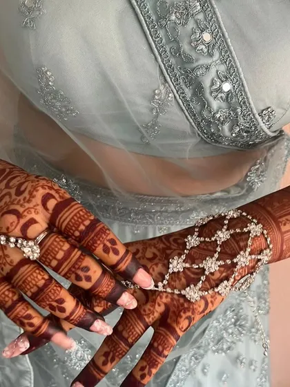 The rich, dark stain of my organic henna, beautifully complemented by elegant hand jewelry. This is the result you can expect with proper aftercare.