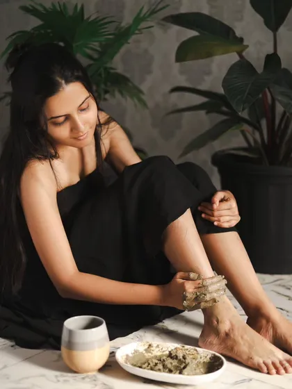 A wider shot to set the scene. The natural elements like the plants and the simple ceramic bowl help build the earthy, Ayurvedic concept.