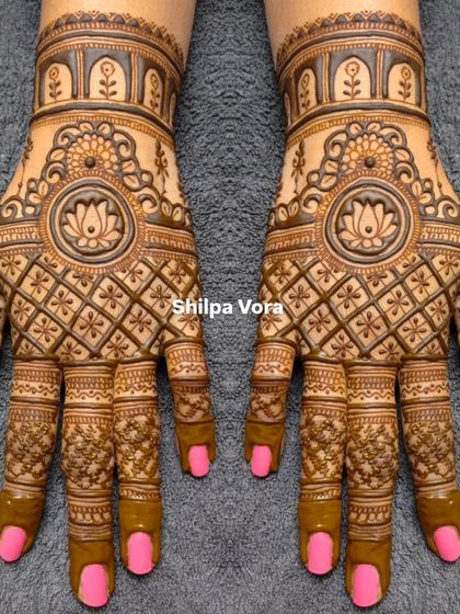 Symmetrical design with a central lotus mandala, surrounded by a classic 'jaal' or net pattern. The solid fingertips complete the traditional look.