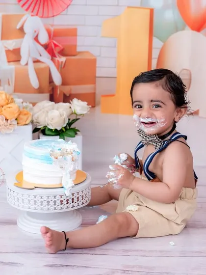 A happy, messy portrait of the birthday boy with his cake. The entire setup is designed for maximum fun and great photos.