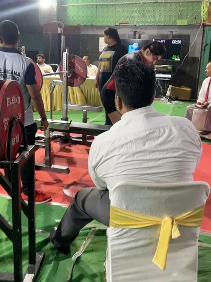 A view from the sidelines as Pooja benches at nationals. As a coach, my job is to make the right calls on the day, like adjusting her attempts when her self-unrack wasn't feeling right, to maximize her total and keep her safe.