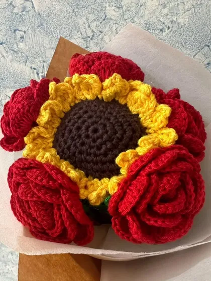 I combined the boldness of red roses with the cheerfulness of a sunflower in this custom bouquet. It’s a beautiful representation of different kinds of love, all handcrafted to create a lasting memory.