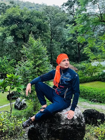 A moment of quiet contemplation in a garden in Rishikesh. My life's purpose is to serve humanity through the path of yoga, and I am grateful for every opportunity to do so.