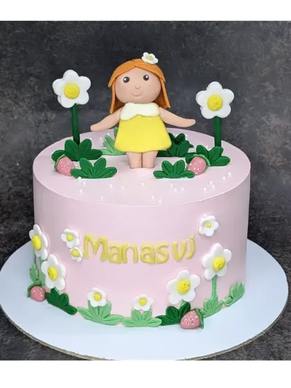 A sweet doll cake set in a strawberry patch. This mixed fruits cake features a handmade fondant doll and flowers, perfect for a little girl's birthday.
