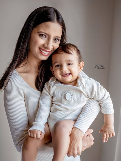 A mother and her son smiling for a portrait.