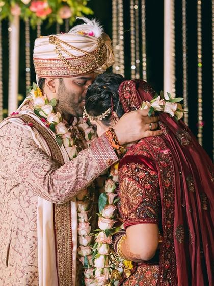 An emotional hug between the groom and bride at the mandap. This photo captures a powerful, unscripted moment of love and support.