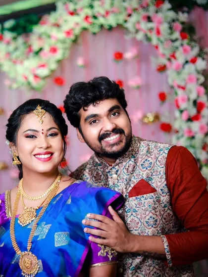 A classic portrait of the happy couple at their engagement ceremony. Their coordinated outfits and the festive decor create a perfect picture.