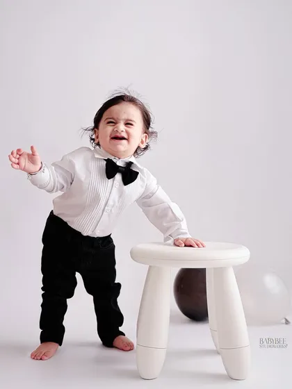 Even the cranky moments are worth remembering. This little gentleman, dressed in a sharp bow tie, shows off his big feelings during his first birthday session.