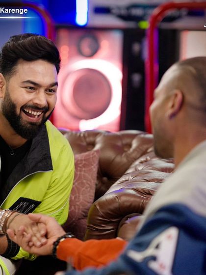 A candid moment of camaraderie between Rishabh Pant and Shikhar Dhawan on the set of 'Dhawan Karenge'. The styling focused on modern, comfortable streetwear.
