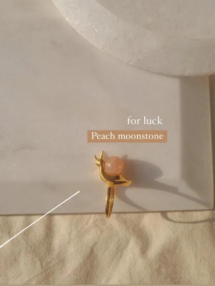The peach moonstone 'snáil' ring, a charm for luck.