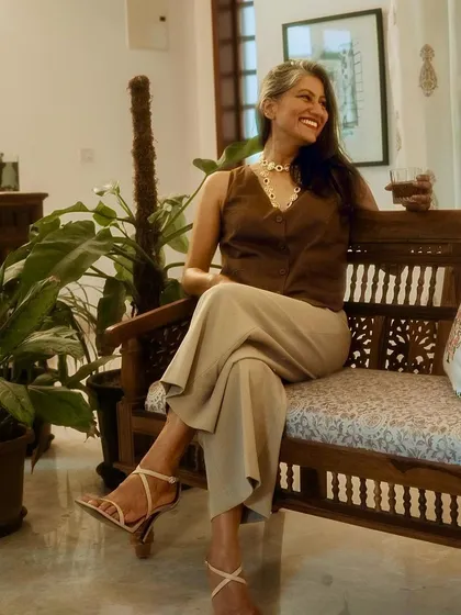This pose shows how the neutral tones of the waistcoat and trousers create a sophisticated and cohesive look.