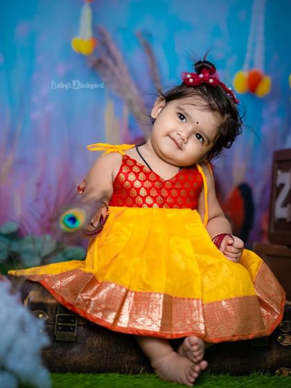 Tiny hands, tiny feet, and a heart that’s oh-so-sweet. A beautiful portrait in a traditional yellow frock.