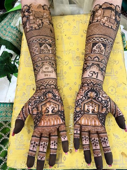 A full bridal mehendi with personalized initials 'SM' and a Sanskrit shloka.