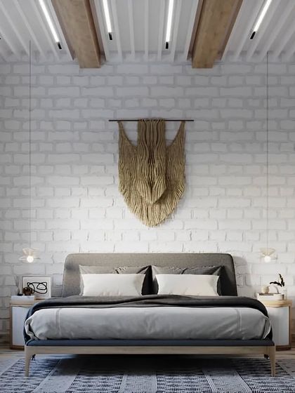 A bohemian-inspired bedroom with a white brick accent wall and a large macrame wall hanging. The design uses natural materials and textures to create a relaxed and artistic vibe.