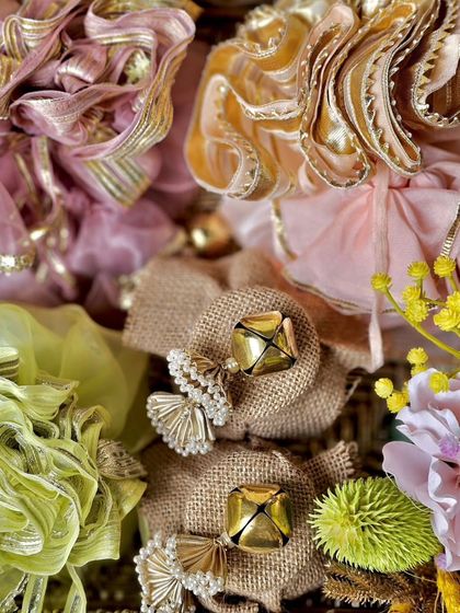 A close-up of the festive potlis inside the Sirohi box. I've used a mix of organza and jute, embellished with traditional ghungroos and pearls, to create a rich, textured look.
