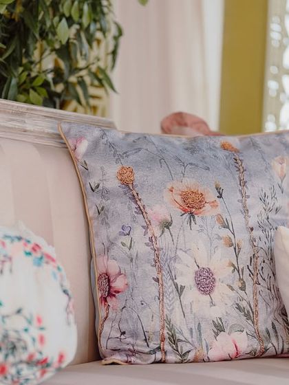 A custom-printed floral cushion, adding a soft and romantic touch to the lounge seating.