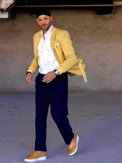 Harbhajan Singh in motion, wearing our yellow striped blazer. The movement shows the comfortable fit and flow of the fabric.