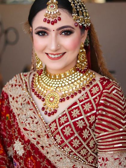 A portrait of our happy bride, looking directly at the camera. Her smile and radiant makeup capture the essence of her special day.