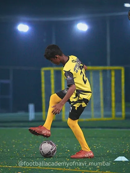 A player practices ball control under the lights, showing dedication to mastering his craft.
