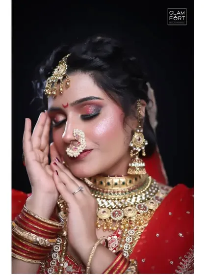 Another stunning bridal portrait. The soft focus and gentle pose highlight the delicate and flawless makeup application, a testament to our detailed training.