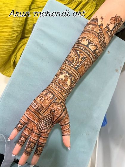 A single arm design filled with a variety of traditional motifs, including peacocks, swans, elephants, and a Ganesha figure.