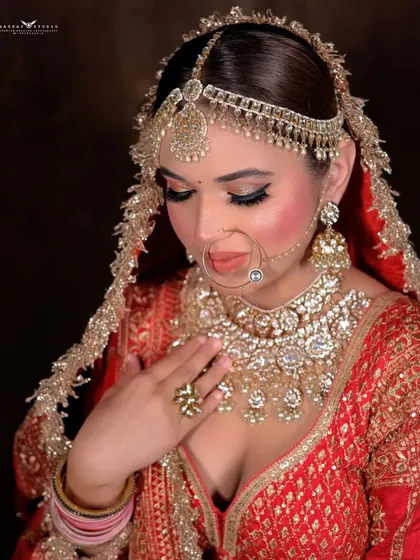 A portrait showing the bride's hand on her chest, highlighting the heavy necklace.