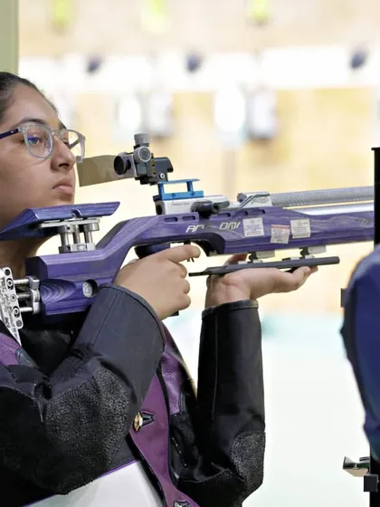 A shooter with her distinctive purple rifle, ready on the firing line. The diversity of athletes and equipment at my events shows the wide appeal and accessibility of the championships I organize.