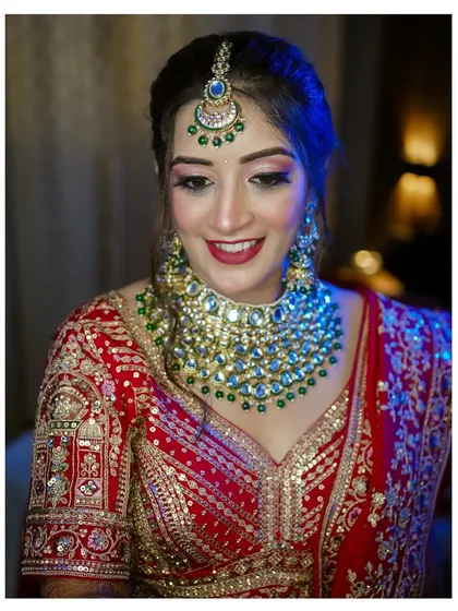 The happy smile of a Punjabi bride. This portrait captures her joy and radiance, with the focus on her beautiful smile and sparkling wedding jewelry.