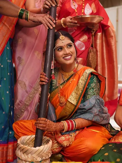 The happiness of a bride surrounded by her loved ones during a traditional ceremony. Her makeup is kept natural to let her joy shine through.