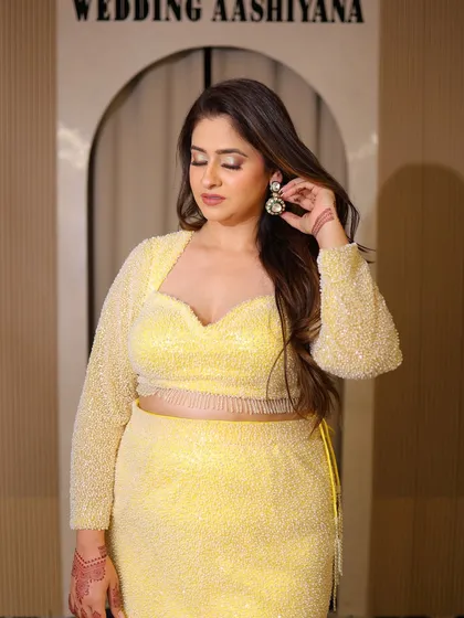 A close-up of the yellow plus-size lehenga, showing the sweetheart neckline and the sparkling fabric of the blouse. It's all about feeling bright and beautiful.