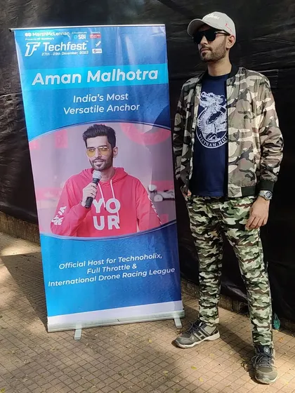 Rocking a camo look for one of the days at Techfest, standing next to my official host banner.