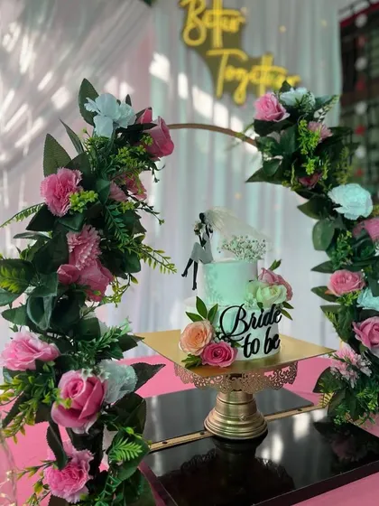 A close-up of the "Bride to be" cake, framed by a delicate floral arch. This shows how I coordinate even the smallest details to fit the overall theme.